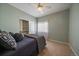 Cozy bedroom with a ceiling fan, window, and closet with sliding doors at 21142 Hawthorne Ln, Parker, CO 80138