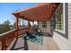 Outdoor deck features a lattice-covered pergola and comfortable seating area for relaxing and entertaining at 21142 Hawthorne Ln, Parker, CO 80138