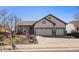 Inviting home featuring a two-car garage, manicured lawn, and delightful curb appeal in a suburban setting at 21142 Hawthorne Ln, Parker, CO 80138