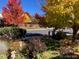 Front yard with vibrant fall foliage and lush landscaping at 21142 Hawthorne Ln, Parker, CO 80138