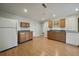 Light-filled kitchen with wood cabinets, durable countertops, white appliances and laminate floors at 21142 Hawthorne Ln, Parker, CO 80138