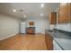 Bright kitchen space with wooden cabinets, laminate flooring, white refrigerator and ample room at 21142 Hawthorne Ln, Parker, CO 80138