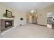 Expansive living room featuring a cozy fireplace, neutral tones and seamless transitions to other living spaces at 21142 Hawthorne Ln, Parker, CO 80138