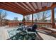 Inviting deck area with comfortable seating, stylish rug and beautiful pergola at 21142 Hawthorne Ln, Parker, CO 80138