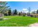Expansive backyard featuring lush green grass and mature trees at 2912 Lake Park Way, Longmont, CO 80503