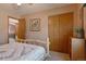 Comfortable bedroom with bed, closet, and doorway at 2912 Lake Park Way, Longmont, CO 80503