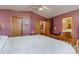 Comfortable bedroom with vaulted ceiling, ceiling fan, and ensuite bathroom entrance at 2912 Lake Park Way, Longmont, CO 80503