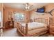 Bedroom with ceiling fan, window, and log-frame bed at 2912 Lake Park Way, Longmont, CO 80503