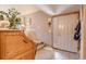 Welcoming entryway with tile flooring, a coat rack, and a view of the staircase at 2912 Lake Park Way, Longmont, CO 80503