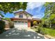 Front exterior of home with large driveway, attached garage, covered porch, and a well-manicured lawn at 2912 Lake Park Way, Longmont, CO 80503