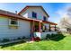 Exterior home view showcasing a covered porch, well-manicured lawn, and classic siding at 2912 Lake Park Way, Longmont, CO 80503