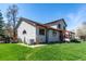 The exterior of the home features a well-maintained lawn, classic siding, and a covered porch at 2912 Lake Park Way, Longmont, CO 80503