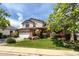 Charming two-story home featuring a well-kept lawn, a two-car garage, and mature trees surrounding the property at 2912 Lake Park Way, Longmont, CO 80503
