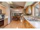 Open kitchen layout leading to a dining area and featuring wooden cabinets at 2912 Lake Park Way, Longmont, CO 80503