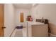 Bright laundry room features washer, dryer, shelving, and ample storage space at 2912 Lake Park Way, Longmont, CO 80503