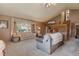 Comfortable living room featuring vaulted ceilings, classic furniture, a large window, and a staircase at 2912 Lake Park Way, Longmont, CO 80503