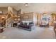 Open-concept living room featuring a fireplace, staircase, and dining area, perfect for entertaining guests at 2912 Lake Park Way, Longmont, CO 80503