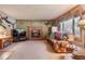 A comfortable living room features a brick fireplace and a view from the window at 2912 Lake Park Way, Longmont, CO 80503