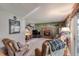 Inviting living room with a brick fireplace, plush seating, and natural light at 2912 Lake Park Way, Longmont, CO 80503