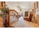 Spacious living room featuring vaulted ceilings, a cozy rocking chair, and a decorative deer head mount at 2912 Lake Park Way, Longmont, CO 80503