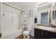 Bright bathroom with a shower-tub combo, granite countertops, and modern fixtures at 5506 S Quemoy Cir, Aurora, CO 80015