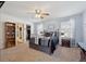 Cozy bedroom with neutral walls, large windows with a ceiling fan, and a plush carpet at 5506 S Quemoy Cir, Aurora, CO 80015