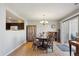 Dining room with wood floors, slider to patio, and chandelier lighting at 5506 S Quemoy Cir, Aurora, CO 80015