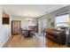 Open dining area with wood floors, natural light, and patio access at 5506 S Quemoy Cir, Aurora, CO 80015