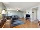 Spacious living room with wood floors, a plush sectional, and a ceiling fan at 5506 S Quemoy Cir, Aurora, CO 80015