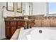 Bathroom with decorative backsplash, granite countertop vanity, and garden tub at 2832 Danbury Ave, Highlands Ranch, CO 80126