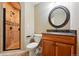 Bathroom with a stylish shower, granite countertop vanity, and decorative framed mirror at 2832 Danbury Ave, Highlands Ranch, CO 80126