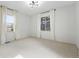 Bedroom with two large windows that provide plenty of natural light and light-colored carpet at 2832 Danbury Ave, Highlands Ranch, CO 80126
