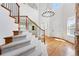 Elegant foyer with a staircase featuring wood and metal detailing, and abundant natural light at 2832 Danbury Ave, Highlands Ranch, CO 80126