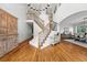 Grand foyer with a striking staircase, chandelier, and gleaming hardwood floors at 2832 Danbury Ave, Highlands Ranch, CO 80126