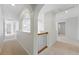Second floor hallway with arched openings, neutral carpet, and white walls leading to various rooms at 2832 Danbury Ave, Highlands Ranch, CO 80126