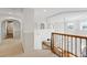 Upstairs hallway featuring decorative railings, arched doorways, and a view of the staircase below at 2832 Danbury Ave, Highlands Ranch, CO 80126