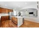 Open kitchen with a center island and bar stools flows into a living area with a fireplace at 2832 Danbury Ave, Highlands Ranch, CO 80126