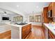 Open kitchen showcasing the island gas cooktop, stainless steel appliances, and hardwood flooring at 2832 Danbury Ave, Highlands Ranch, CO 80126