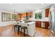 Well-lit kitchen includes a central island with bar seating, stainless steel appliances, and wooden cabinetry at 2832 Danbury Ave, Highlands Ranch, CO 80126