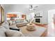 Cozy living room with a gray sectional, fireplace, and open access to the adjacent kitchen at 2832 Danbury Ave, Highlands Ranch, CO 80126