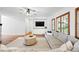 Bright living room featuring a comfortable gray sectional, decorative coffee table, and built-in media center at 2832 Danbury Ave, Highlands Ranch, CO 80126