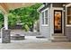Inviting outdoor patio area with stone fire pit, covered wood ceiling, and access to the home's interior at 2832 Danbury Ave, Highlands Ranch, CO 80126