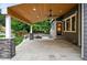 Covered patio featuring a stone fire pit, access to the home, stone columns, and ceiling fans at 2832 Danbury Ave, Highlands Ranch, CO 80126