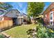 Beautiful backyard with lush green grass, a two story deck, and a mix of greenery and flowers at 511 S Pennsylvania St, Denver, CO 80209