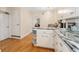 Bright, open kitchen with hardwood floors, marble countertops, and white cabinets at 511 S Pennsylvania St, Denver, CO 80209