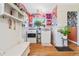 Bright laundry room with colorful wallpaper, light hardwood flooring, and modern washer and dryer units at 511 S Pennsylvania St, Denver, CO 80209