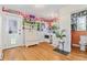 Bright laundry room with colorful wallpaper, light hardwood flooring, and modern washer and dryer units at 511 S Pennsylvania St, Denver, CO 80209