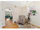 Cozy sitting area with an armchair, hardwood floors, and view into the living room at 511 S Pennsylvania St, Denver, CO 80209