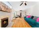 Spacious living room with hardwood floors, decorative fireplace, ceiling fans, and comfortable seating at 511 S Pennsylvania St, Denver, CO 80209