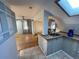 Open living space featuring a kitchenette, hardwood floors, and a sliding barn door at 511 S Pennsylvania St, Denver, CO 80209